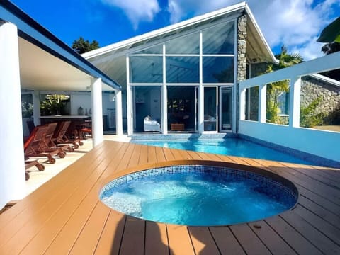 hot tub with pool that is a step down from living area