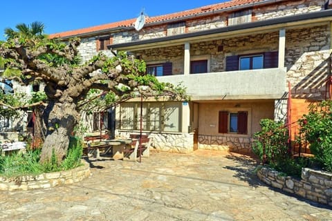 The outside of the house and the private parking in front of the house in the courtyard