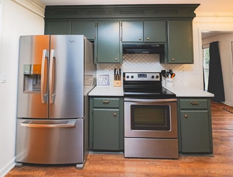 kitchen-stainless steel refrigerator with ice maker, stove/oven.