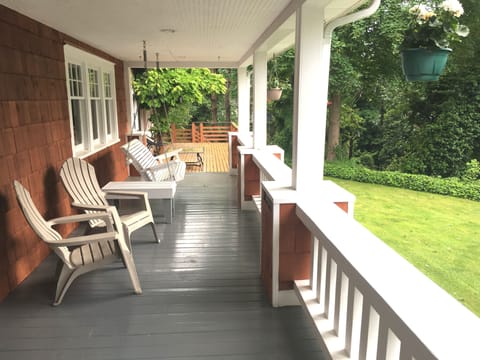 Wrap around porch with a cozy porch swing, perfect for a relaxing evening.