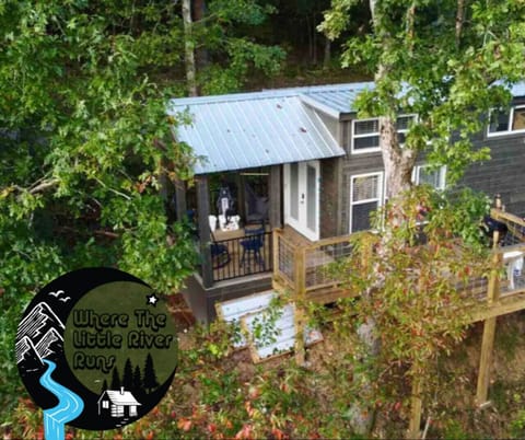 Aerial View overlooking the home. The East Fork of The Little River flows gently down the hill side from the home running into Lake Lahusage where you can kayak, fish, and swim. Come stay at Where The Little River Runs