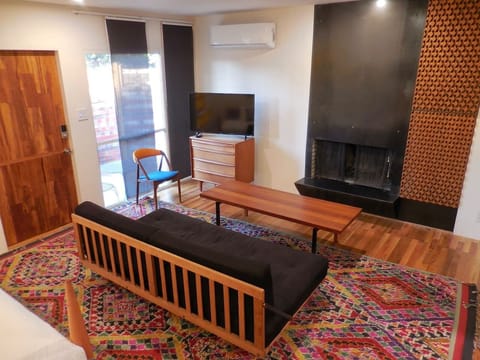 Solid teak coffee table, wood burning fireplace, Roku TV.  