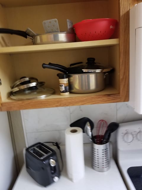 kitchen pots and pans with toaster, some utensils