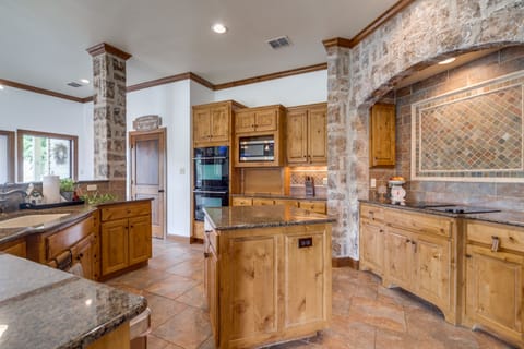 Cook spectacular meals in this spacious kitchen with views of the pool.