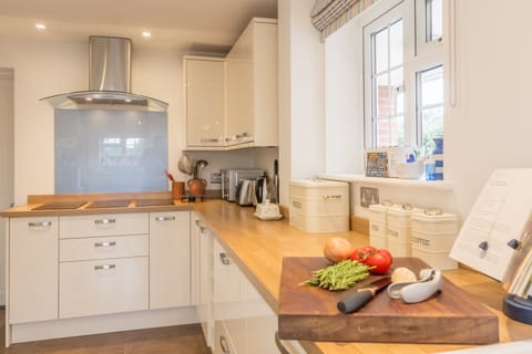 Ground floor: Well-equipped kitchen with with induction hob, extractor fan, two electric ovens, fridge/freezer and dishwasher