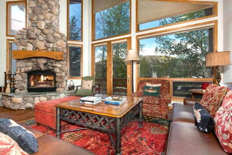 Warm yourself with this rock enclosed wood fireplace while reading a book in the living room