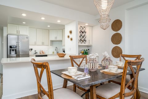 Mini bar and open concept to kitchen. Stone dining table.