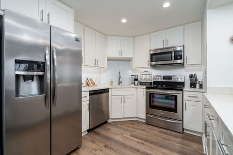 Updated kitchen with quartz countertops & stainless steel appliances.