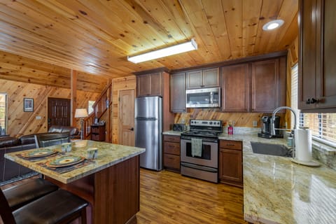 Open kitchen next to two sliding glass doors leading out to the patio.