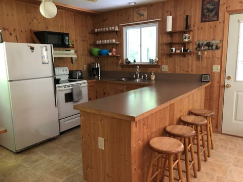 The full kitchen that opens up into the living room space.