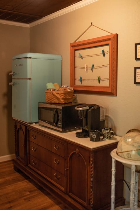 Kitchenette stocked with coffee, tea, snacks, creamers, and sugars.