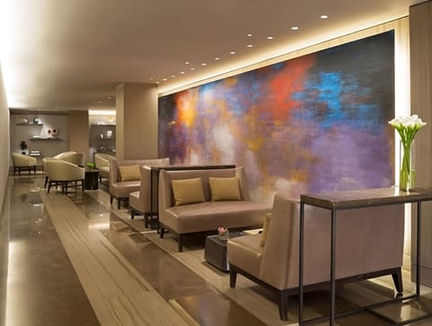 Settle in beside bold artwork and enjoy a calm lobby moment.