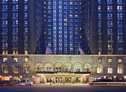 Arrive in style beneath glowing lights at the grand entrance
