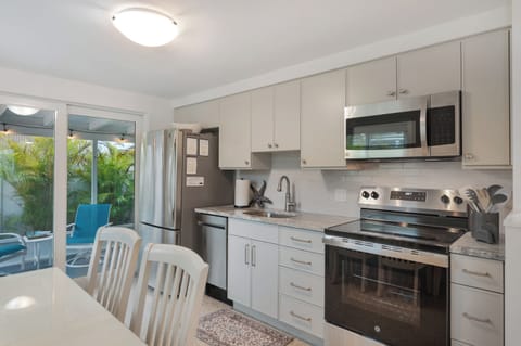 A fully equipped kitchen including a dishwasher and microwave