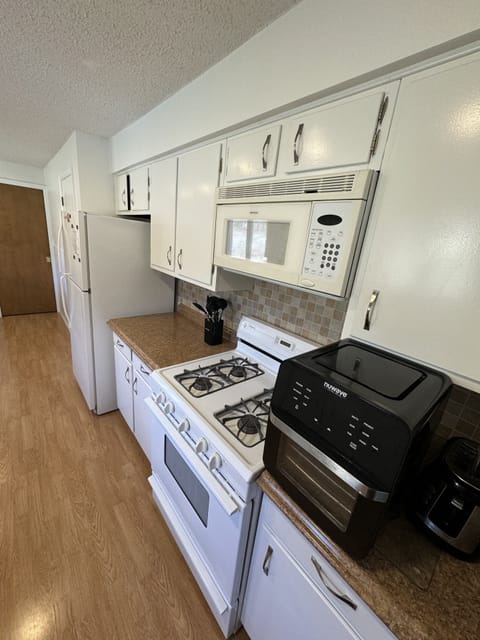 Fully equipped kitchen with high top table with 4 chairs. Door to laundry room 