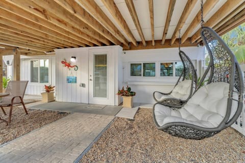 Your cozy beach get away awaits you! Enjoy relaxing in the hanging swing chairs just outside your front door.