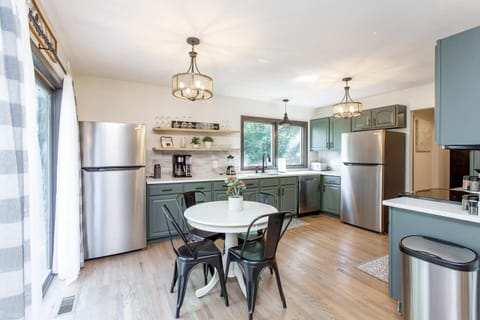 The kitchen is on the main level of the home and has Quartz countertops, tile backsplash, SS appliances and eat-in dining area