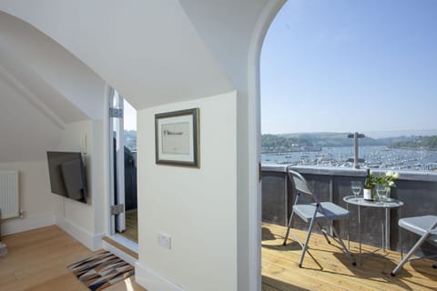 Living room with feature windows and access to the balcony with wonderful river views - Waterview House