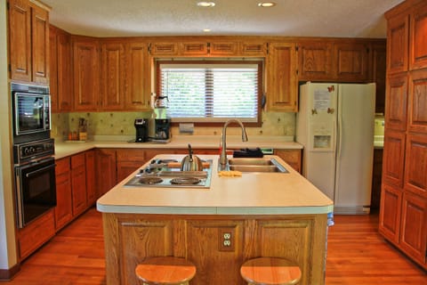 Fully equipped kitchen with dishes, cookware, and retro appliances. 