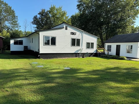Front of house; deck wraps around the side and back of house.