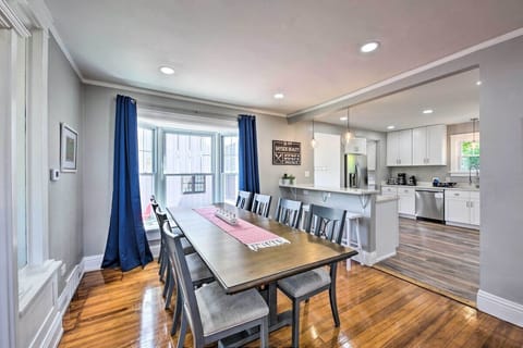 Kitchen table with 8 chairs and a window cushion.