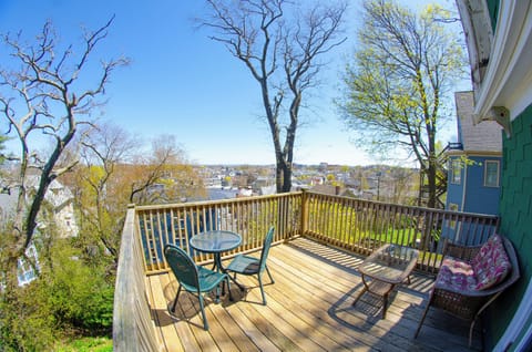 Balcony with table, chairs, coffee table and loveseat.