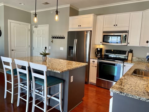 Updated kitchen with island seating. Fully stocked for all your cooking needs.