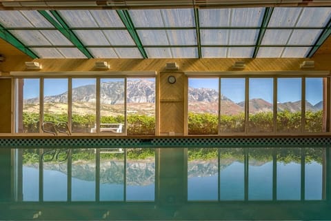 Indoor pool with glass doors and roof view bring the oudoors in! + slide, spa/Jacuzzi and kitchen