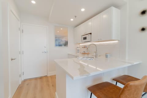 Large, fully stocked kitchenette. Microwave, 2 seater bar counter. Mini fridge, Keurig coffee maker, glasses, plates, and cutlery.

