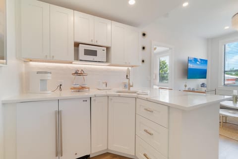 Large, fully stocked kitchenette. Microwave, 2 seater bar counter. Mini fridge, Keurig coffee maker, glasses, plates, and cutlery.

