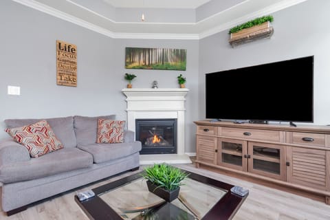 Living room with gas fireplace and smart TV.
