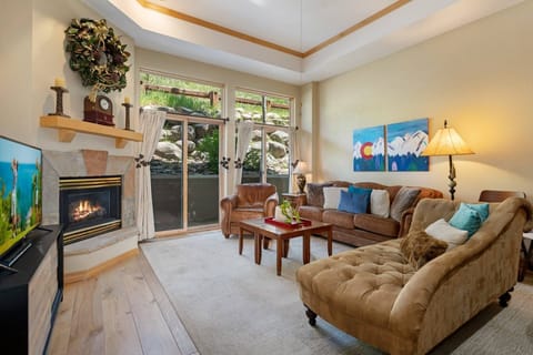 Bright welcoming living room with fireplace, flat screen TV and plenty of seating!