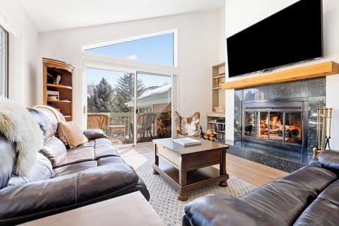 Living room with stunning mountain views and wood burning fireplace