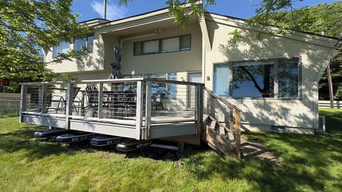 Expansive deck facing the lake with paddleboards stored  below for easy access