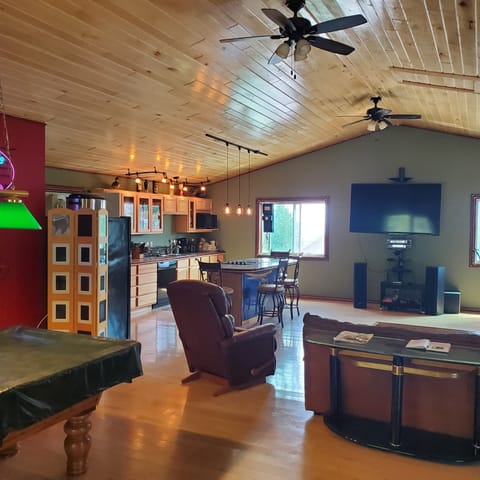 Greatroom view from entryside. Entertainment system, with Alexa in background.