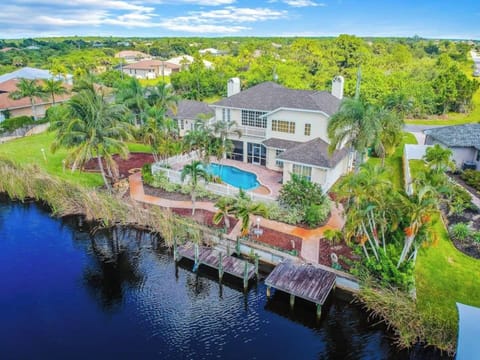 Spacious Home With 7 bedrooms, 5 Bathrooms, 2 Kitchen Areas And 3 Livingroom Areas. Heated Pool And Canal With Boat Docks Available For You To Bring Your Boat Or rent One During Your Stay. Quiet Residential Neighborhood.
