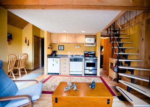 Stairs lead to loft with twin bunkbeds and single bed. 