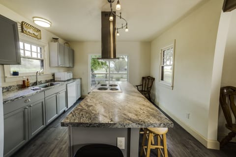 Bright kitchen with sliding glass door to front porch.