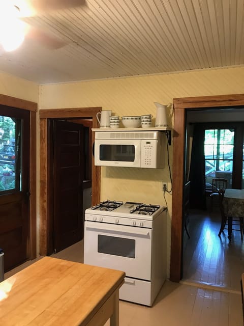 Kitchen stove and microwave - looking into dining room.
