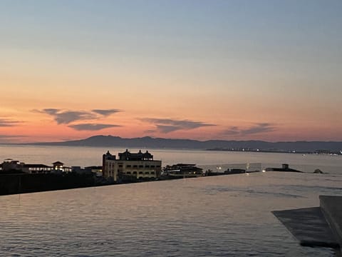 Rooftop view of the pool and ocean during a beautiful sunset moment.