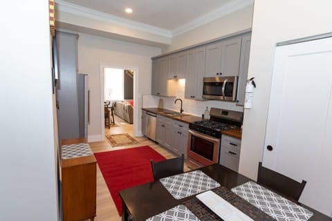 A luxuary kitchen, with plenty of cabinets and cooking prep space.  Large 6 burner stove, coffee station, and smaller table. 