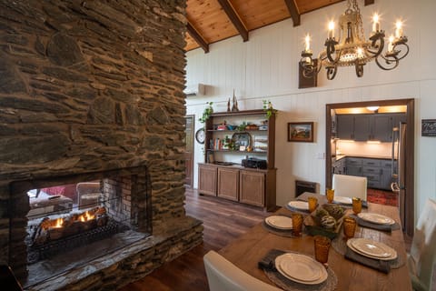 Dining Area with fireplace & view out back of house.