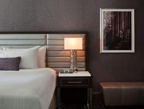 Settle in with warm bedside lighting and curated artwork.