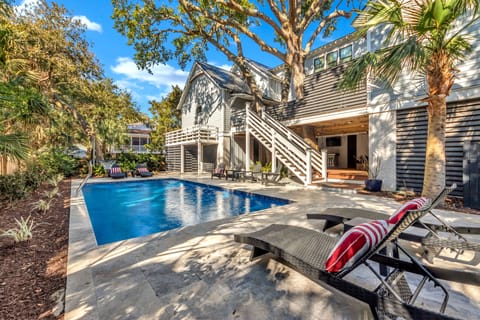Private backyard retreat featuring a sparkling pool and relaxing lounge chairs.