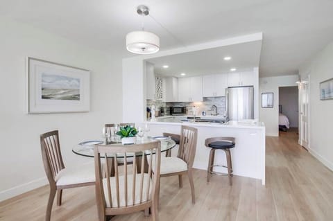 Calming tones and minimalist decor set the stage with dining for 4 and breakfast bar stools for 2