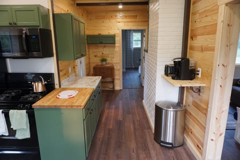 Keurig and toaster with enough pots and pans and utensils to prepare meals