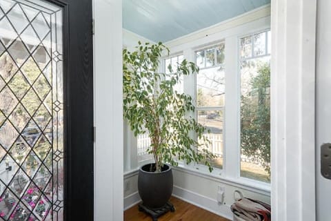 Sunny enclosed porch welcomes guests