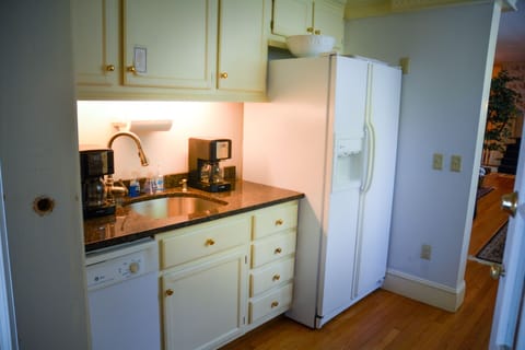 Coffee bar with coffee machines, teapots, second dish washer and refrigerator.