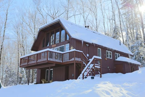 Winter View of the Chalet Concordia at dusk with lights in The White Mountains