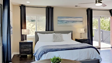 King Size Bed, 2 Bedside Tables, Lamps, Remote Controlled Ceiling Fan, Light and Bright with 2 windows and French Doors with full length Glass windows.